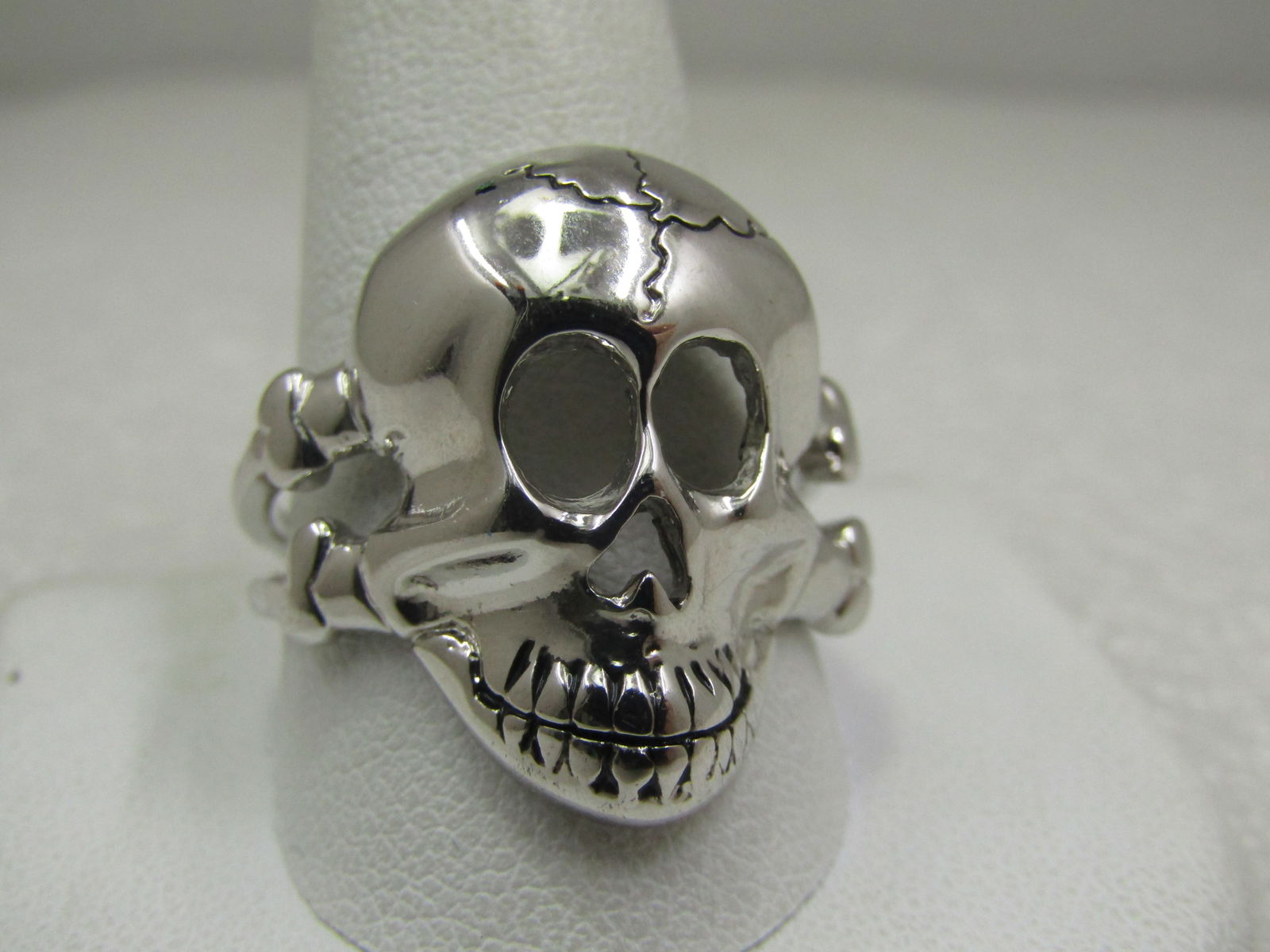 Men's Skull Biker Ring, Sz. 12.5, Silver Tone: Men's Skull Biker Ring, Sz. 12.5, Silver Tone. The ring is appx. 1" down and across the top of the finger with a skull and two bones coming out from the sides creating a double band at top shoulds tha