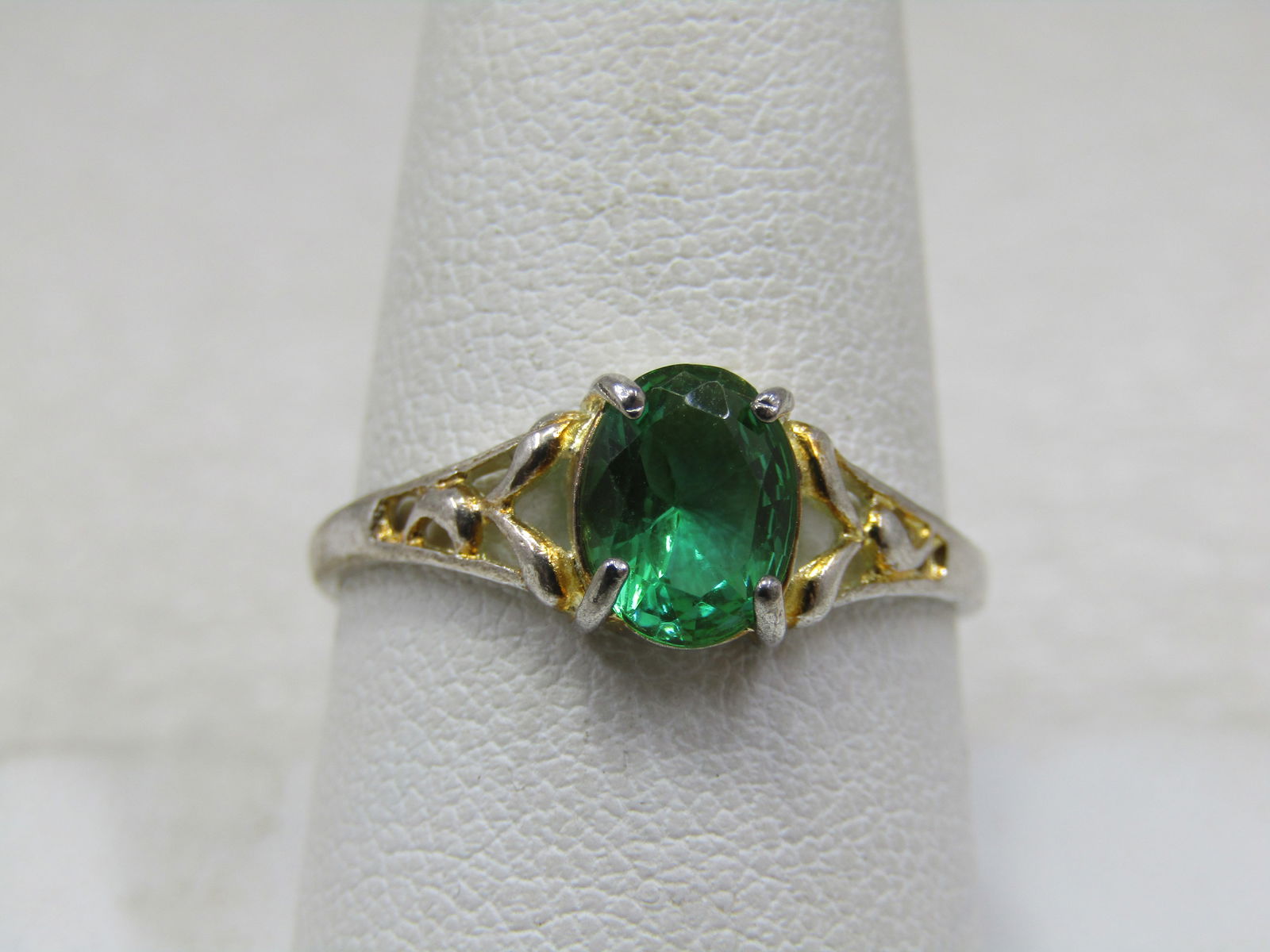 Silver Plated Green Stone Ring, Sz. 9.5, Scrolled: Silver Plated Green Stone Ring, Sz. 9.5, Scrolled design with open areas on each side of the stone. The stone is an oval, appx. 7mm by 6mm. It is silver tone/plated and marked .925 but does not test a