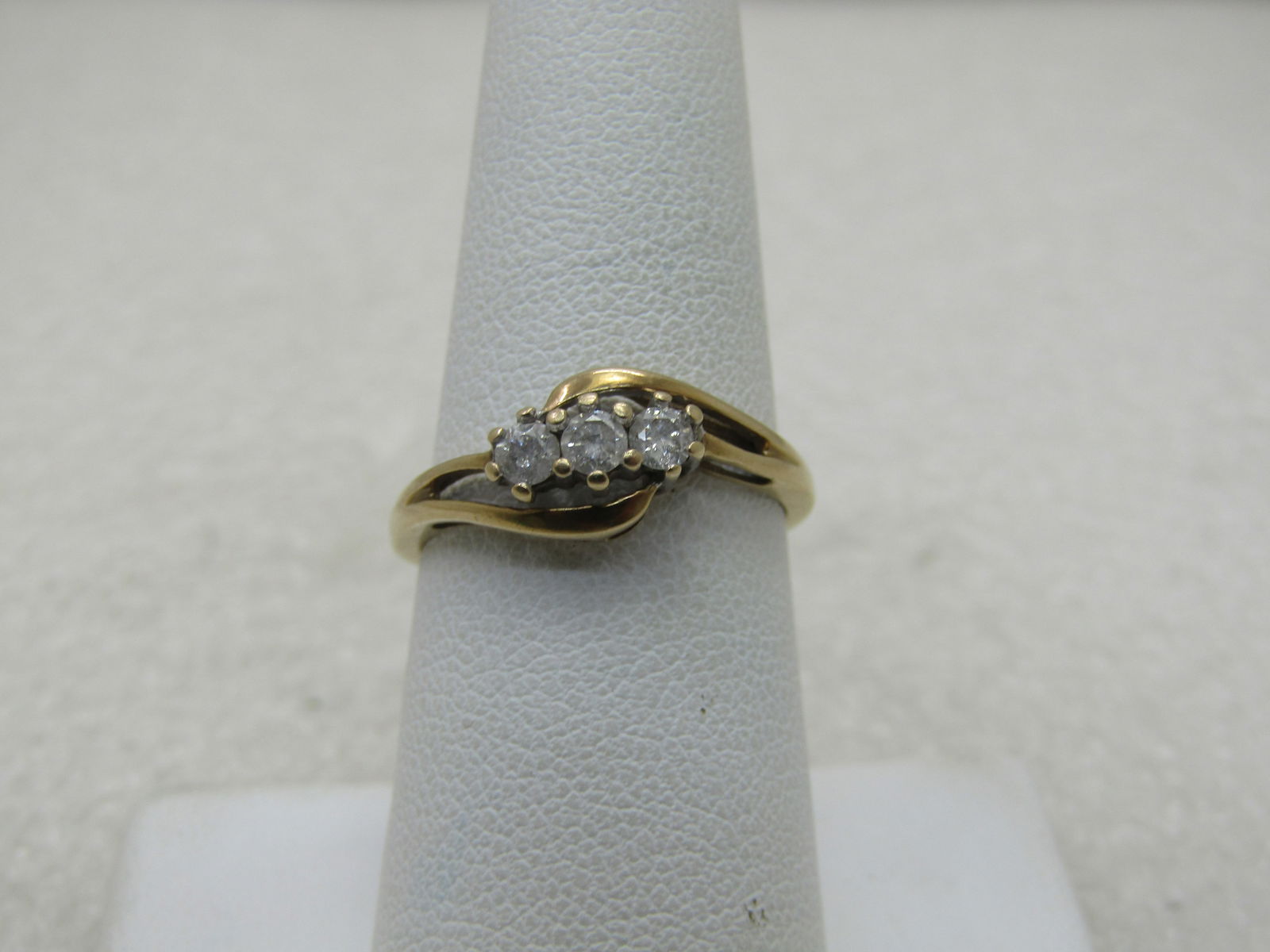 Vintage 10kt Triple Diamond Bypass Ring, Sz. 7.25, Signed JB, 1.88 gr: Vintage 10kt Triple Diamond Bypass Ring, Sz. 7.25, Signed JB inside diamond outline with a U in front. Appx. 1.88 gr. The diamonds weight is appx .60 TCW, three stones that are each appx. 3mm to