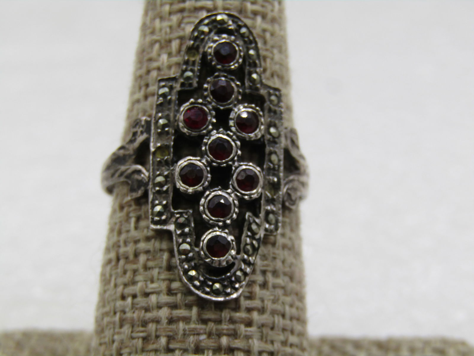 Vintage Sterling Garnet Marcasite Ring, Sz. 8.5: Vintage Sterling Garnet Marcasite Ring, Sz. 8.5, The ring ahs 9 red stones that test as garnet and sit slightly higher than the frame which is a halo of marcasites. There were three missing which have