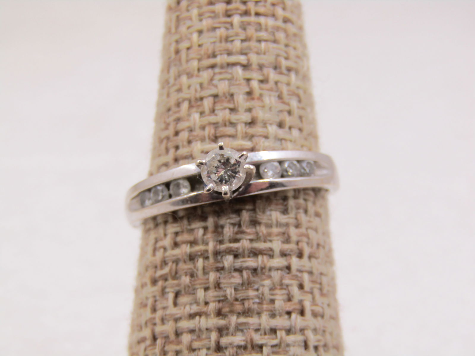 Vintage 14kt White Gold Engagement Ring .25 CTW, Sz. 7, Signed: Vintage 14kt White Gold Engagement Ring .25 CTW, Sz. 7, Signed with a diamond shape and what looks like Mi, also marked 14kt and tested. Weight is appx. 2.31 grams. Round cut diamond that is appx. .25