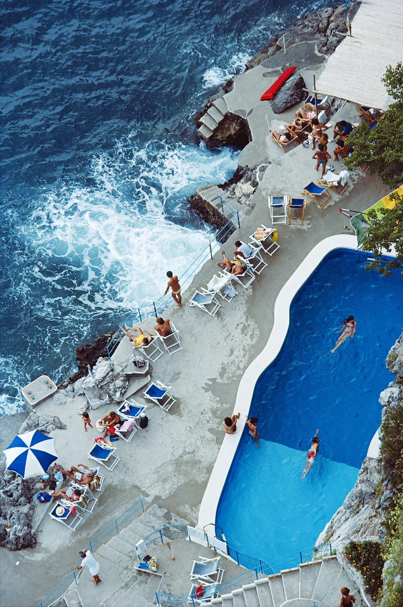 Slim Aarons Estate Print - Pool On Amalfi Coast - Oversize: 1984 (printed later): Title: Slim Aarons Estate Print - Pool On Amalfi Coast - Oversize: 1984 (printed later) Description: Pool On Amalfi Coast A view of the seaside pool at the Hotel St. Caterina, Amalfi, Italy,