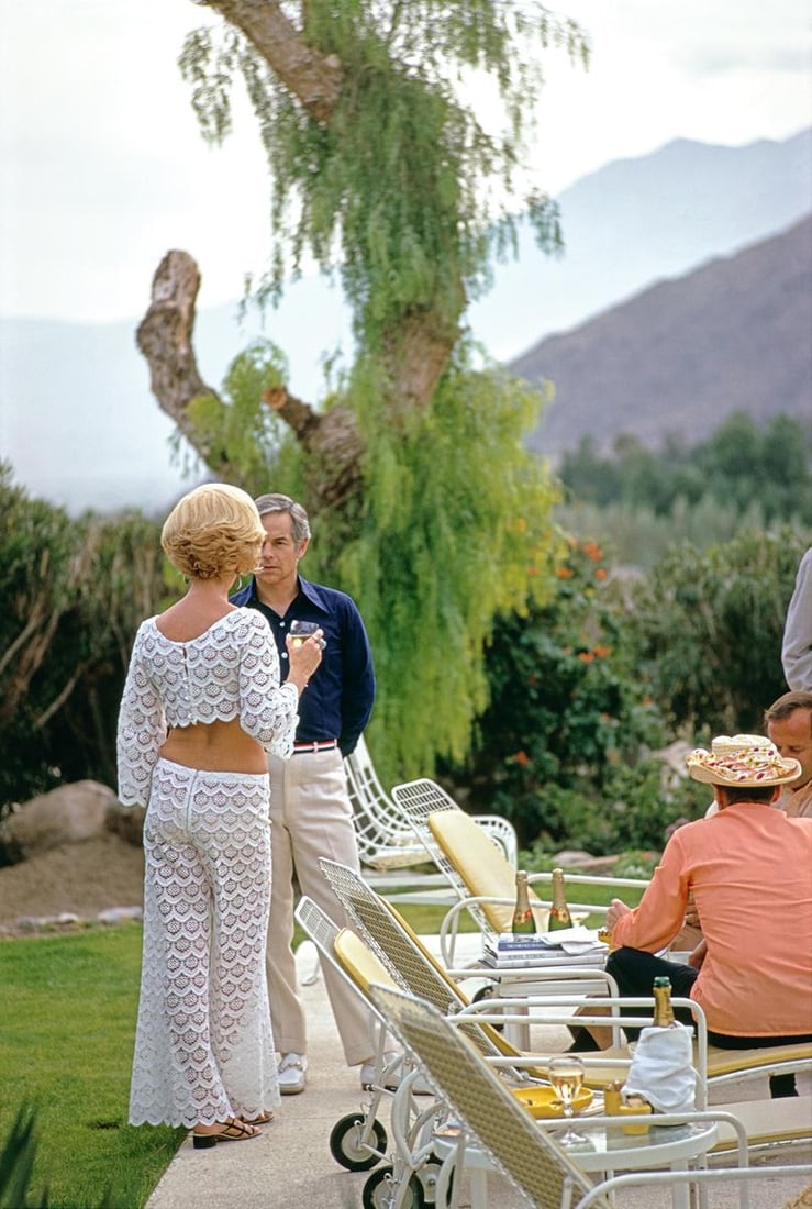 Slim Aarons Limited Estate Edition Poolside Friendship: 1970 (Printed Later): Title: Slim Aarons Limited Estate Edition Poolside Friendship: 1970 (Printed Later) Description: Slim Aarons Limited Estate Edition Poolside Friendship Nelda Linsk (left, in yellow), wife of art deale