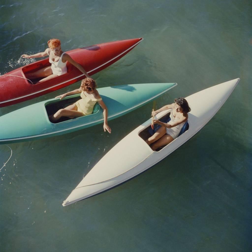 Slim Aarons Lake Tahoe Canoes Estate Stamped Edition: 1959 (printed later): Title: Slim Aarons Lake Tahoe Canoes Estate Stamped Edition: 1959 (printed later) Description: Lake Tahoe Canoes' Young women canoeing on the Nevada side of Lake Tahoe, 1959. Three young women are pic