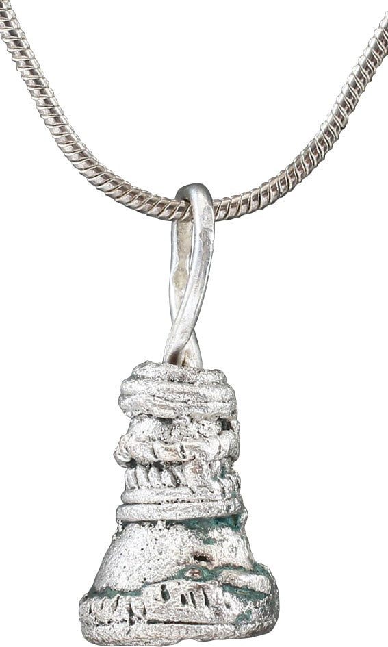 CELTIC VOTIVE BELL, 7th-5th CENTURY BC: Silvered bronze, over 1/2" height plus the loop. Cast with intricate transverse and beaded bands decoration by the lost wax process. The plain form are generally acknowledged as exchange objects (mone