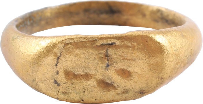 MEDIEVAL CHRISTIAN RING, SIZE 7 ½: Gilt bronze, size 7 ½ of hefty proportions with 3.0mm rounded band flaring to the shoulders. Oval bezel incised with a cross in four detached elements, with crescents above and below. Dating abou