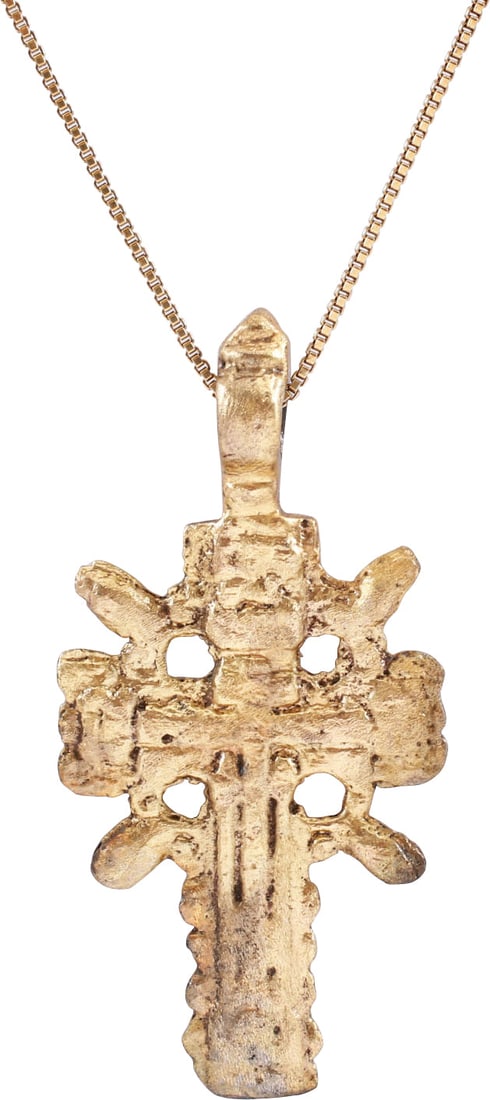 RARE LARGE EASTERN EUROPEAN CROSS, 17TH CENTURY: Gilt bronze, over 1 3/4" in height. Slightly broad beams with a scalloped halo and radials at the quarter points describing a saltire. Central relief vacant cross with the charges and footrest delinea