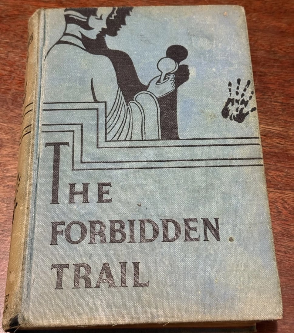 The Forbidden Trail Lilian Garis 1933 1st Ed. Mystery HC Good Condition Grosset: The product is a first edition hardcover book titled "The Forbidden Trail" by Lilian Garis, published by Grosset & Dunlap in New York, 1933. It is a mystery thriller intended for children. This collec