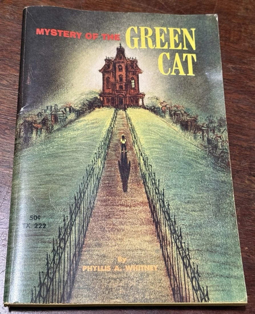 Mystery of the Green Cat Phyllis A. Whitney Paperback Scholastic 5 Th Print 1966: The "Mystery of the Green Cat" by Phyllis A. Whitney is a paperback book published by Scholastic in 1966, 1st edition 5th printing. It belongs to the mystery genre and is set in the 1960s era. The boo