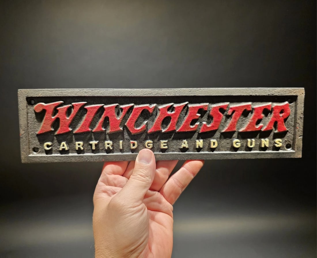 12" Cast Iron Winchester Plaque Sign: Title: 12" Cast Iron Winchester Plaque Sign Description: 12" wide x 3" tall Wonderful reproduction Winchester firearms plaque. Good detail, all cast iron and hand aged to look like an antique. 