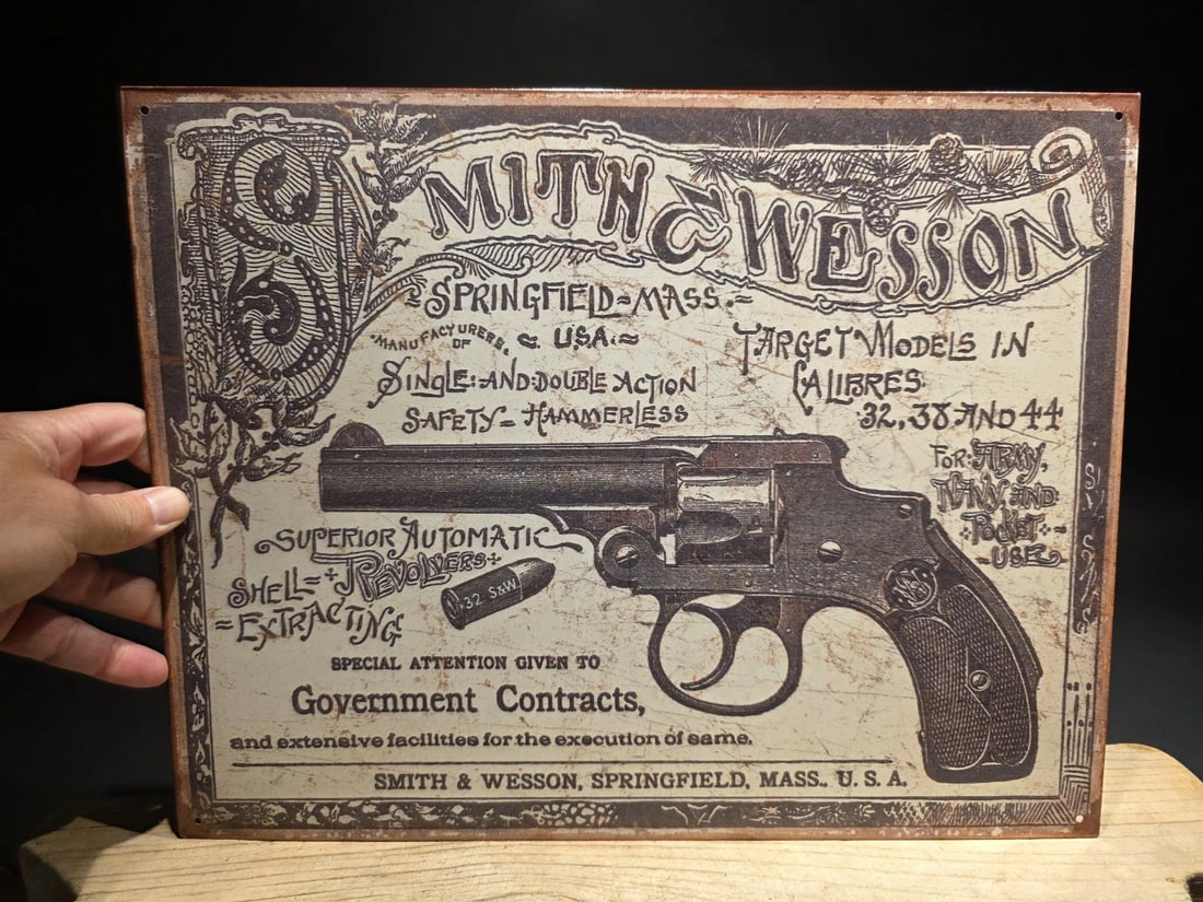 Smith & Wesson Tin Sign 1892 Revolver Advertisement: Title: Smith & Wesson Tin Sign 1892 Revolver Advertisement Description: 16" x 12 1/2" Vintage-Style Smith & Wesson Tin Sign – 1892 Revolver Advertisement Reproduction This vintage-style tin sign