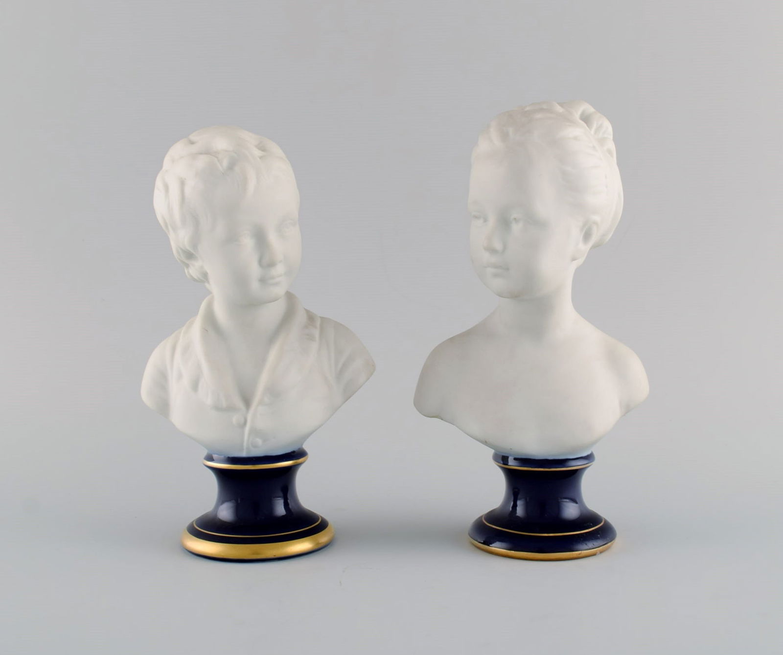 Limoges France. Two child busts in biscuit. Stand with dark blue glaze and gold edges. Classic (1 of 10)
