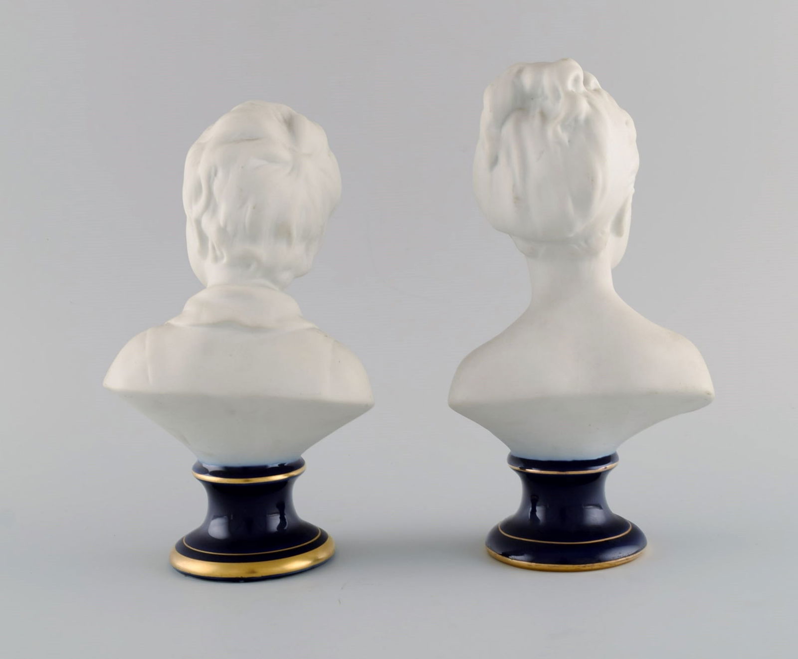 Limoges France. Two child busts in biscuit. Stand with dark blue glaze and gold edges. Classic - 2