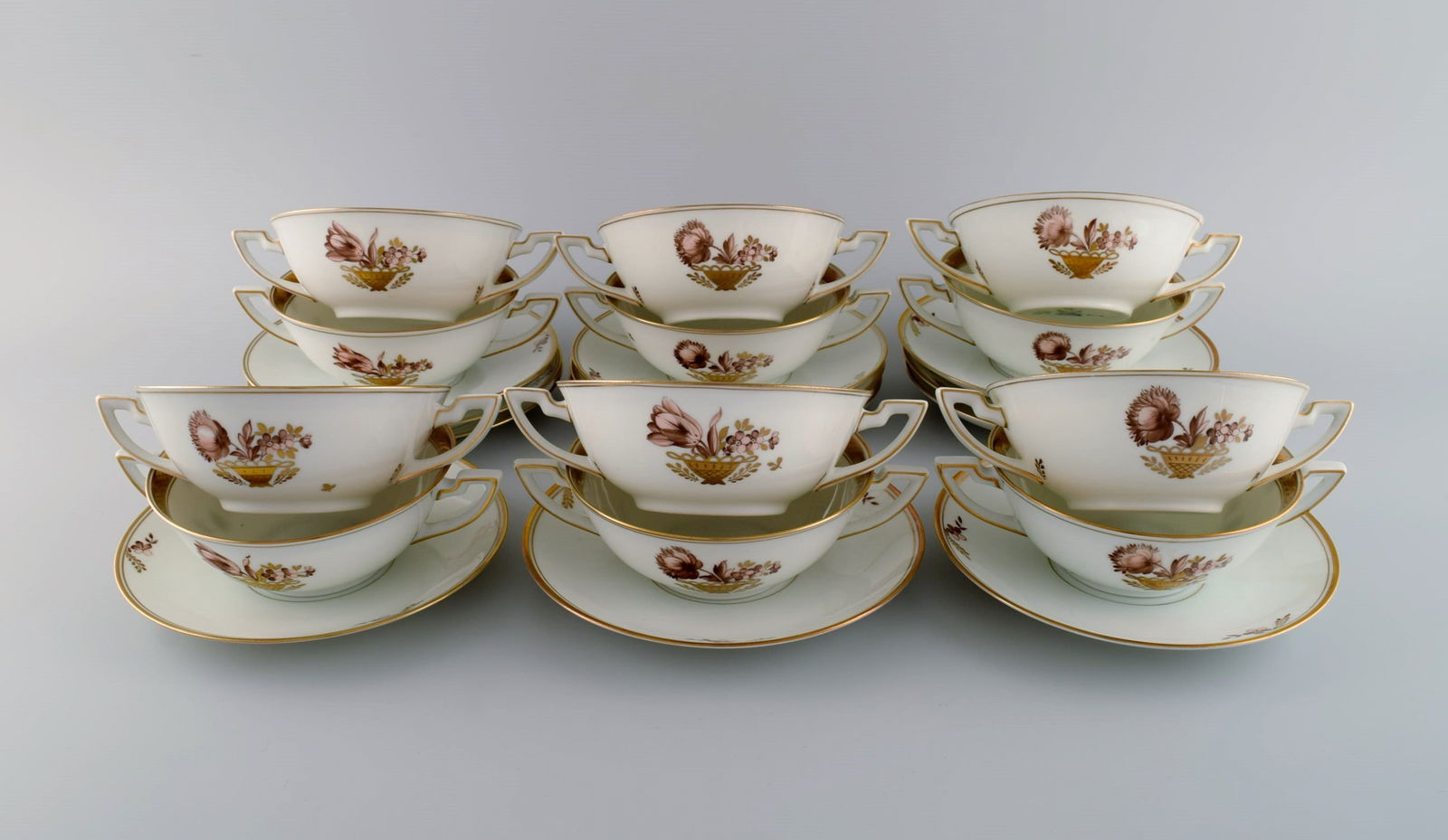 Twelve Royal Copenhagen Golden Basket bouillon cups with saucers.: Title: Twelve Royal Copenhagen Golden Basket bouillon cups with saucers. Description: Twelve Royal Copenhagen Golden Basket bouillon cups with saucers. Model number 595/9571. Dated 1889-1922. The cup