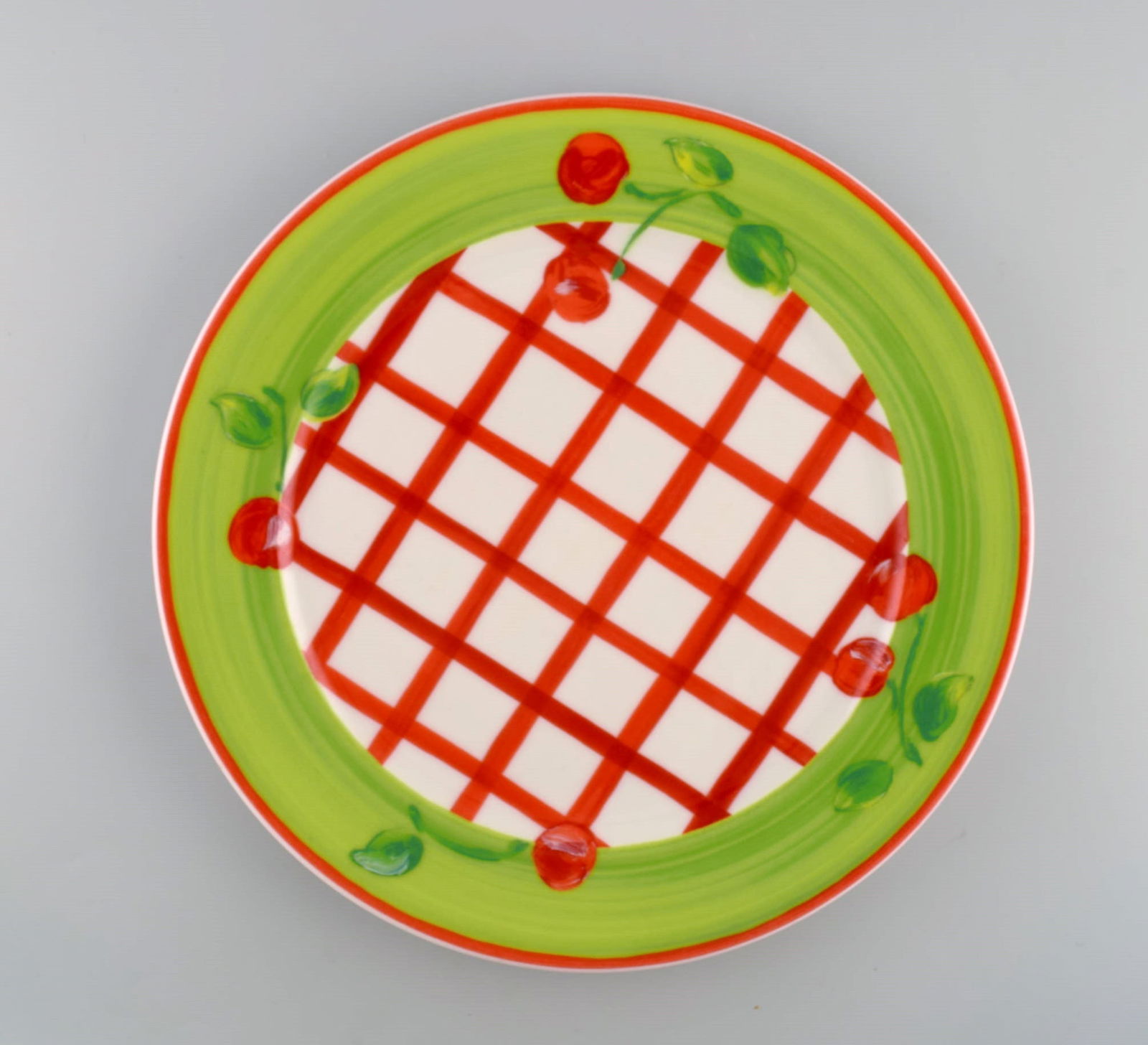 Rosenthal Designers Guild. Orchard Collection. Large porcelain cover plate. Checkered design, green: Title: Rosenthal Designers Guild. Orchard Collection. Large porcelain cover plate. Checkered design, green border and cherries. Late 20th century. Description: Rosenthal Designers Guild. Orchard