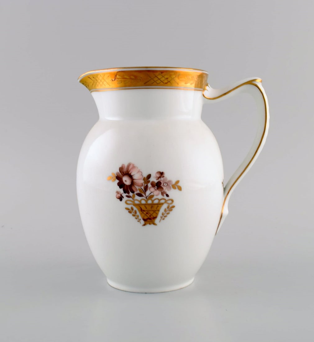 Royal Copenhagen Golden basket jug in porcelain with flowers and gold decoration. Model number (1 of 6)