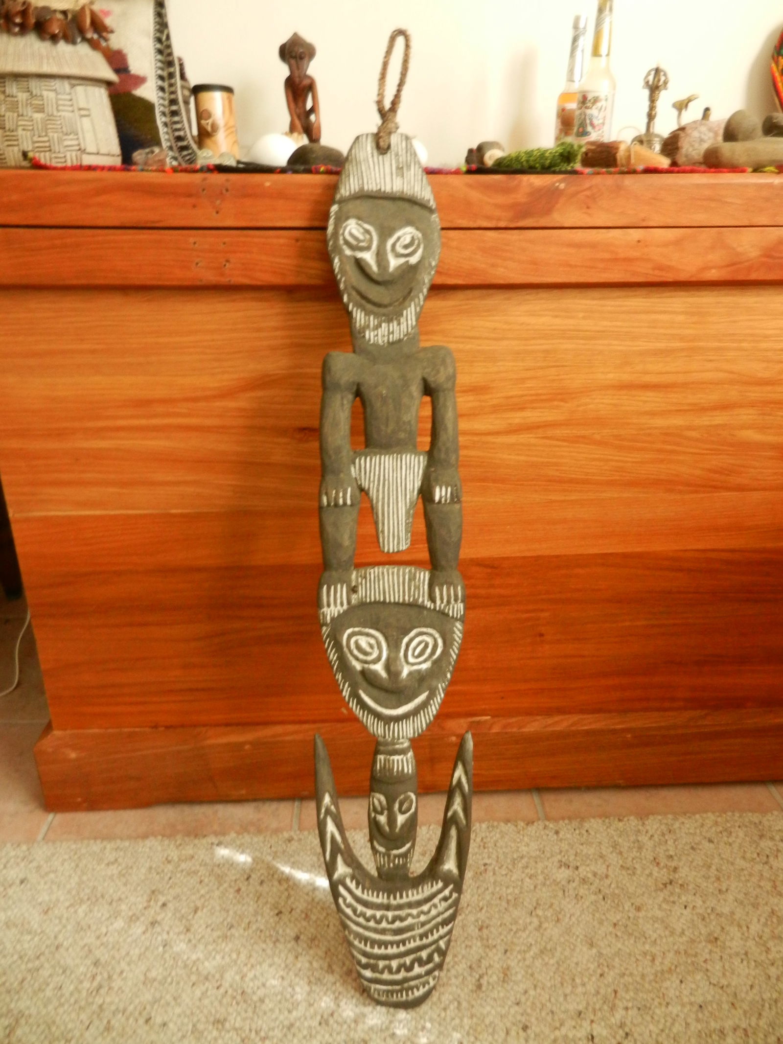 Food Hook: Title: Food HookDescription:Carved wooden food hook with lime detail of male figure standing on another spirit face. These hooks are used to hang food from the rafters to keep it out of reach of