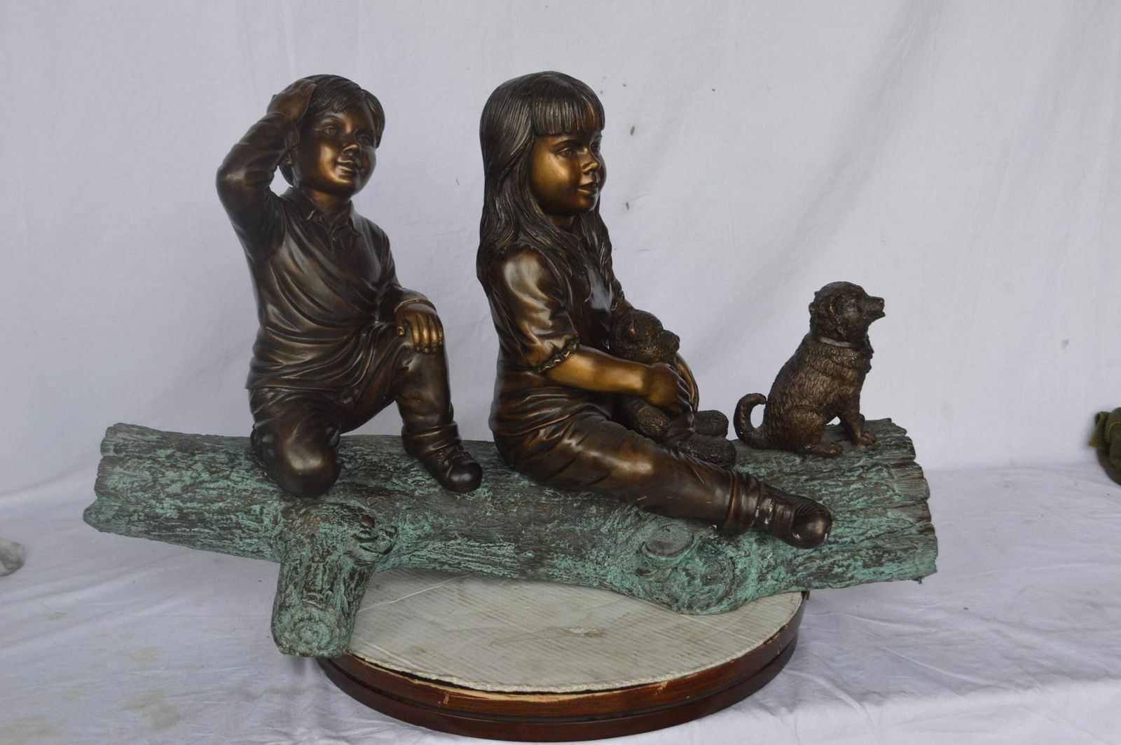 Young children and dog on a log bronze statue - Size: 40"L x 16"W x 24"H. - 4