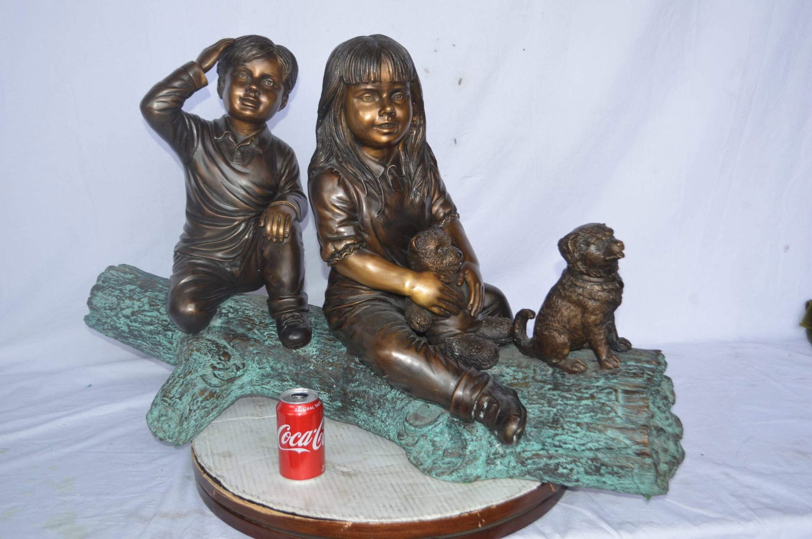 Young children and dog on a log bronze statue - Size: 40"L x 16"W x 24"H. - 5