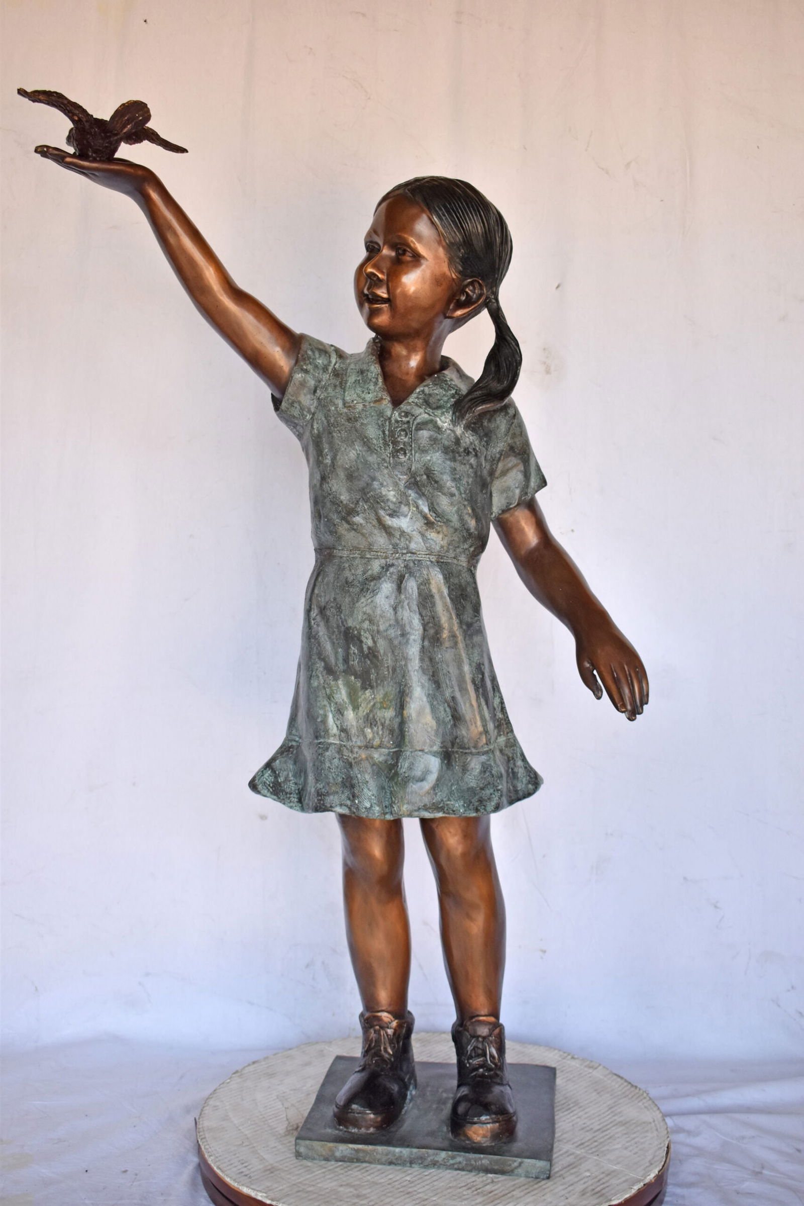 Young Girl Holding a Bird Outside at The Park - Size: 21"L x 11"W x 49"H. - 13