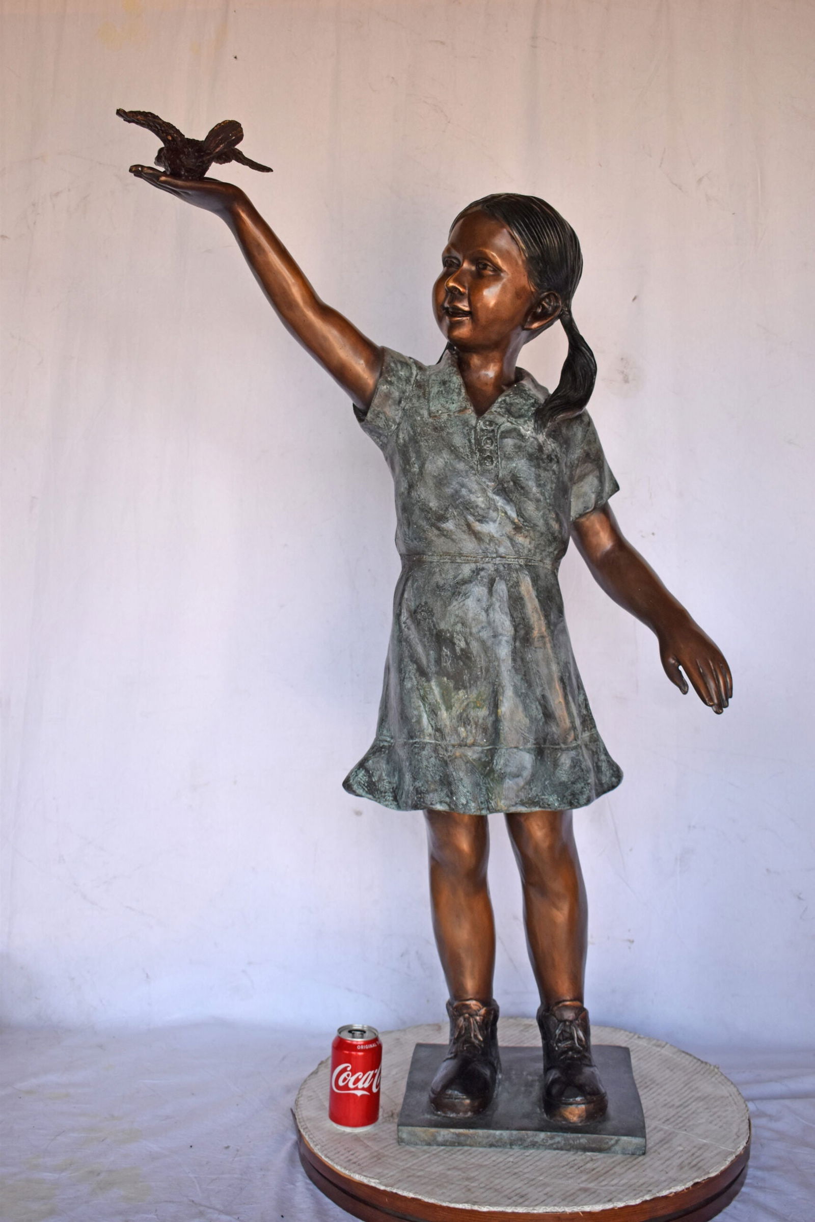 Young Girl Holding a Bird Outside at The Park - Size: 21"L x 11"W x 49"H. - 2