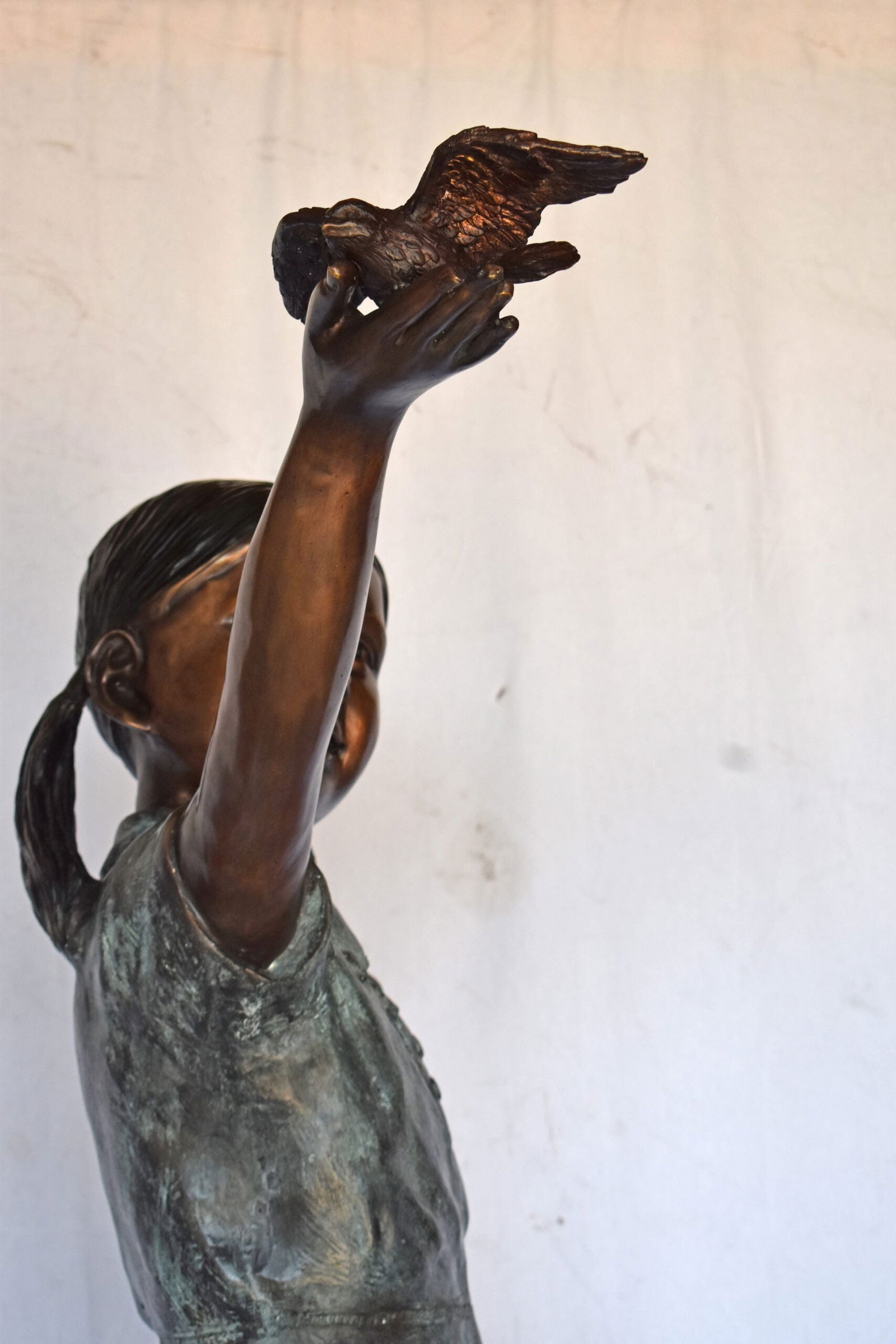 Young Girl Holding a Bird Outside at The Park - Size: 21"L x 11"W x 49"H. - 9