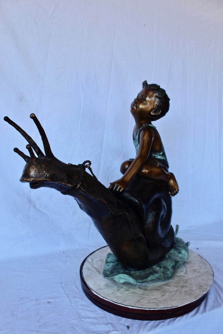 Happy boy riding a snail bronze statue fountain - Size: 42"L x 14"W x 34"H. - 10