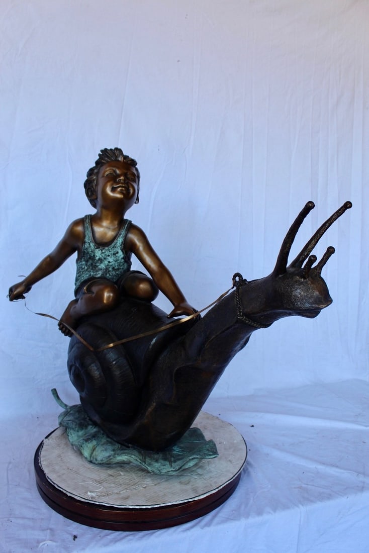 Happy boy riding a snail bronze statue fountain - Size: 42"L x 14"W x 34"H. - 12