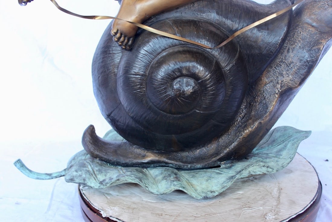 Happy boy riding a snail bronze statue fountain - Size: 42"L x 14"W x 34"H. - 14