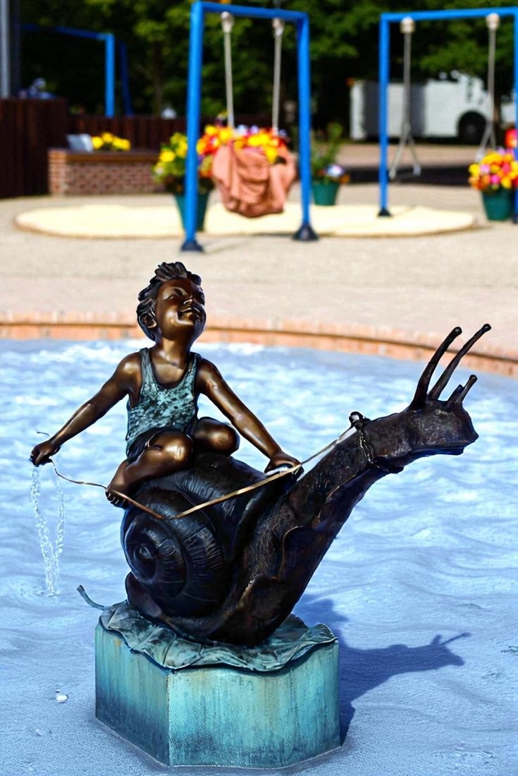 Happy boy riding a snail bronze statue fountain - Size: 42"L x 14"W x 34"H. - 4