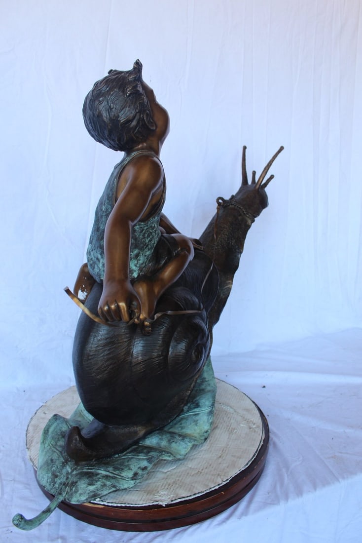 Happy boy riding a snail bronze statue fountain - Size: 42"L x 14"W x 34"H. - 7
