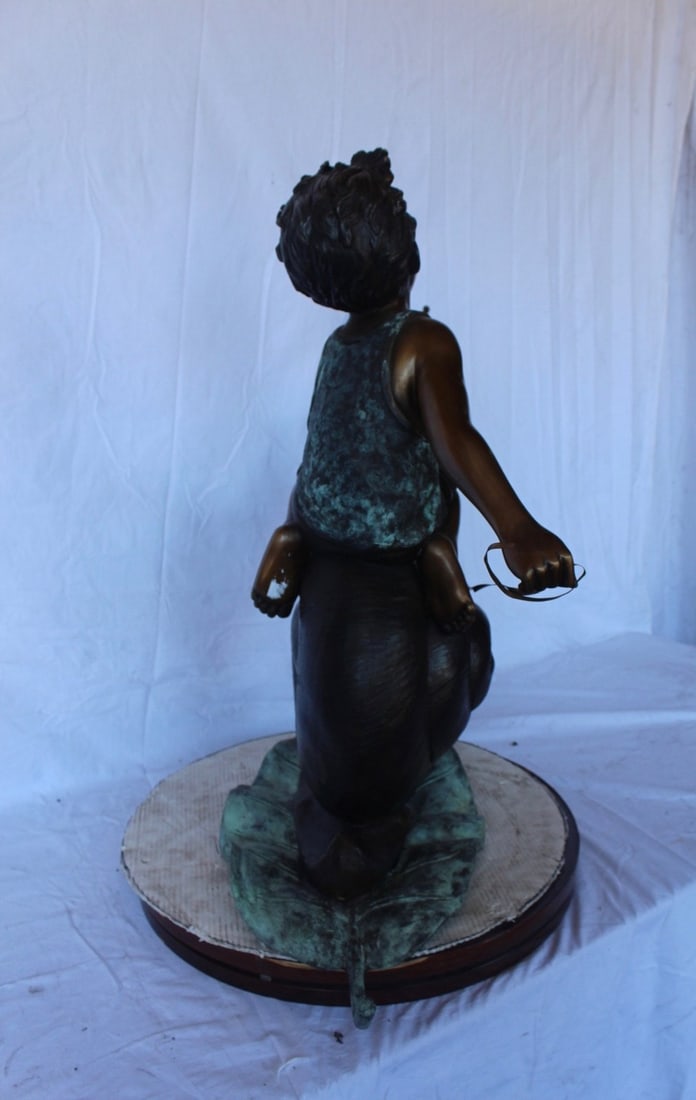 Happy boy riding a snail bronze statue fountain - Size: 42"L x 14"W x 34"H. - 8