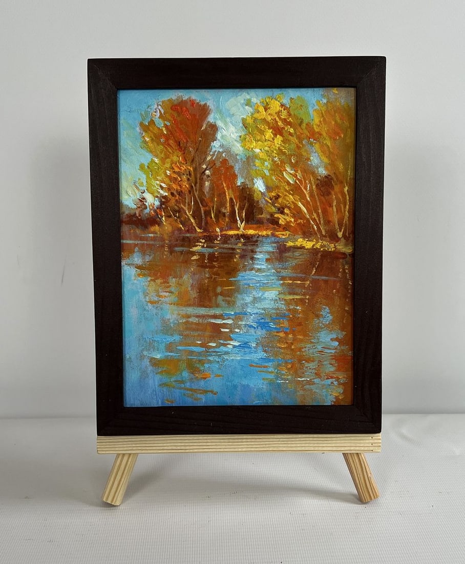 Oil painting Golden reflection of the forest Yuriy Suprunchuk: NoAAA4309 The painting "Golden Reflection of the Forest" masterfully captures the vibrant beauty of autumn as it dances across the surface of a tranquil river. Using oil on cardboard, the artist has