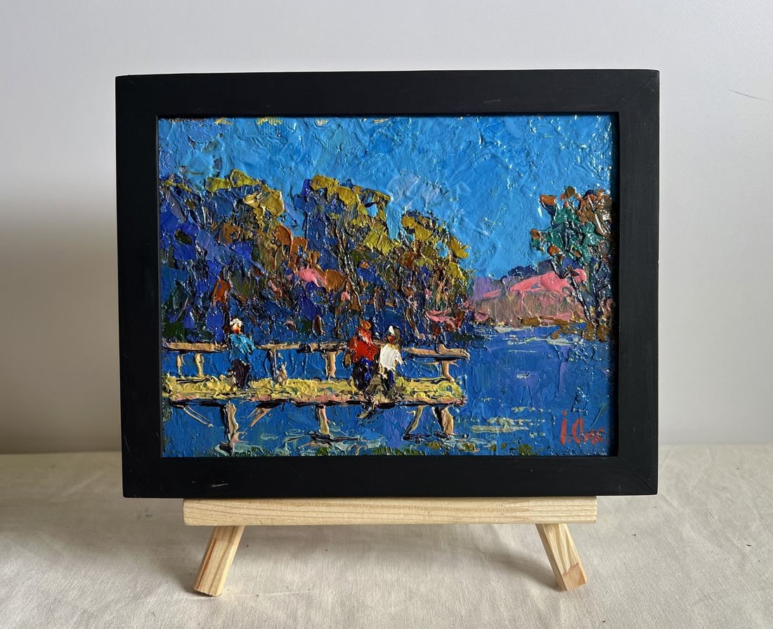 Oil painting Admiring the river Oksana Kalenyuk: NoAAA3943 This oil painting cardboard, titled "Admiring the river", the composition is centered around a rustic wooden bridge extending over the shimmering water, with figures adding a sense of human