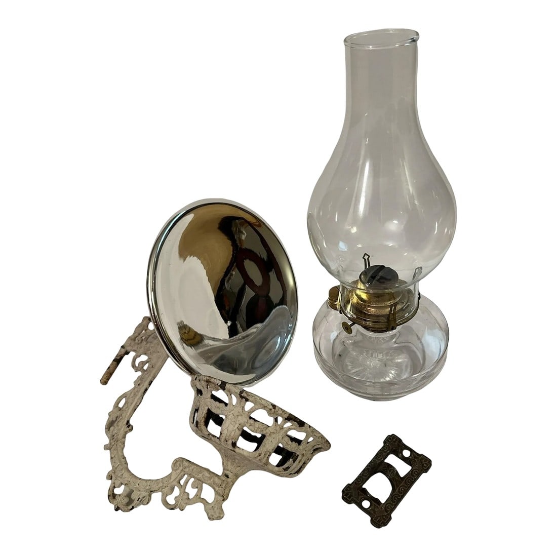 Early 20th Century Cast Iron Holder Oil Lamp Wall Sconce Candle Holder - 4 Piece Set: Antique Stover Gilt Cast Iron Oil Lamp Holder Wall Sconce with Bracket & Reflector Oil Lamp and Glass Hurricane Included Reflector and Bracket are included Lamp wick is not included Rustic