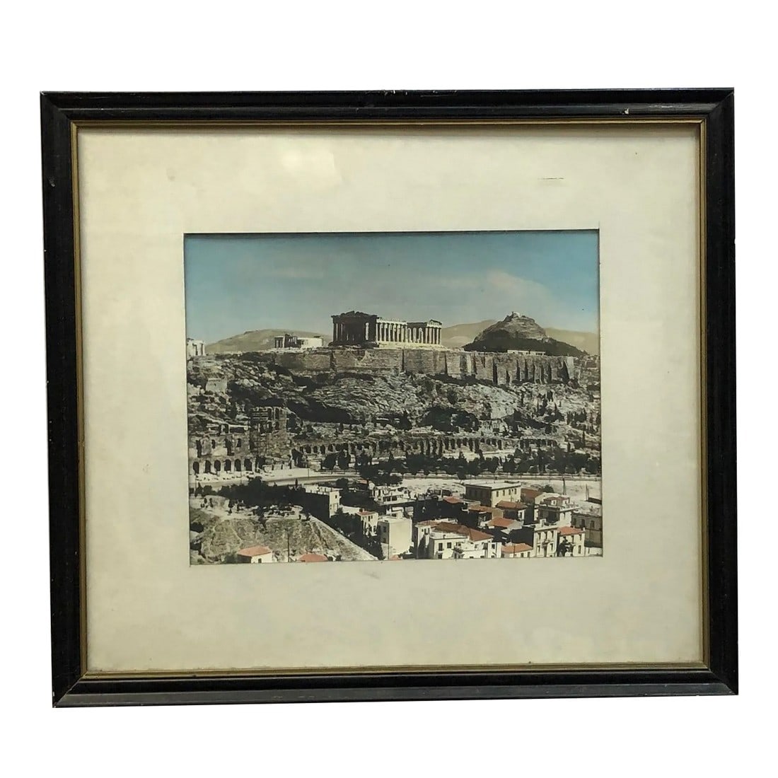 Mid 20th Century Colored Photograph of the Acropolis in Athens Greece: This is a colored photograph of the Acropolis in Athens, Greece - 18.5" x 16.5", framed in a classic black and gold-trimmed border. The image captures the iconic Parthenon standing atop the rocky