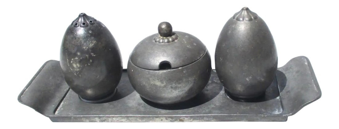 Just Pewter Table Setting - a Set of 4 Pieces: Danish designed set by Just Andersen in pewter from the '30s. Salt, pepper, and sugar pot with a lid on a fitted serving tray. Grey pewter cast with the JUST logo to undersides. Salt has a white