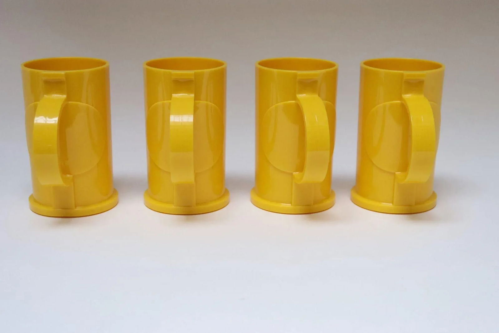 Set of Four Mid Century Modern Yellow Plastic Mugs / Tumblers by Gunnar Cyren for Dansk - 4