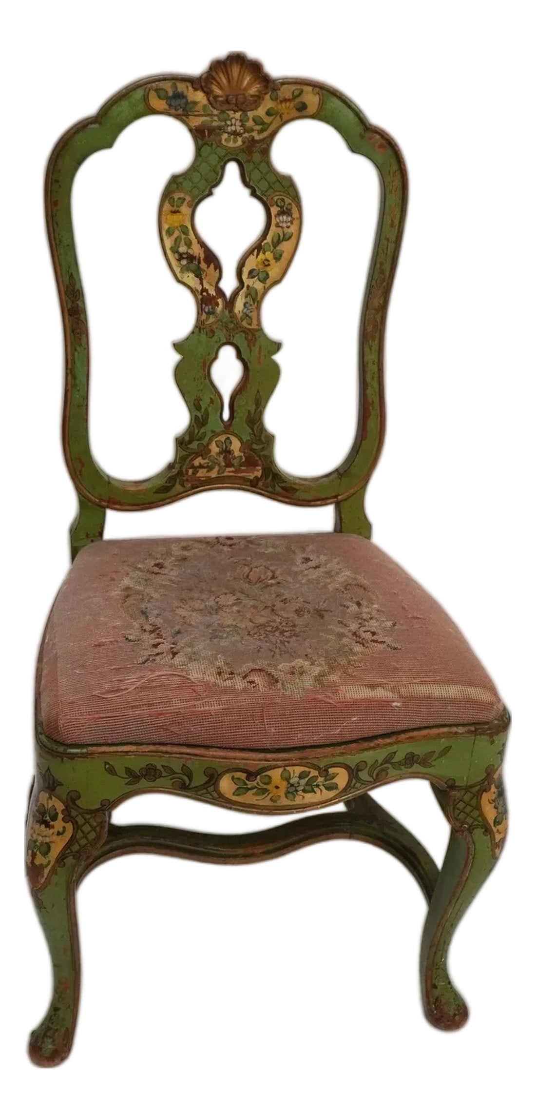 Late 19th Century Green Painted Chair With Needlepoint Seat: A green-painted chair with floral motifs and scrollwork. Cabriole legs, piered back splat, a shell crest at the top of the chair with a needlepoint upholstered seat. Overall, the color palette is mute