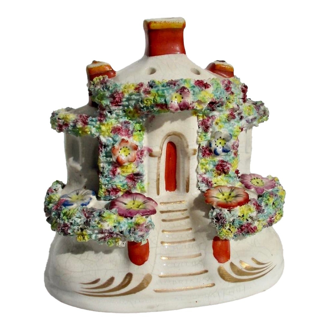 Antique Staffordshire Pastelle Burner Circa 1850s: Beautifully made little Staffordshire ceramic inscense burner in the form of a little flower-covered house. Pretty and lovely little pansies feature lush flower trim over the home. The incense cones