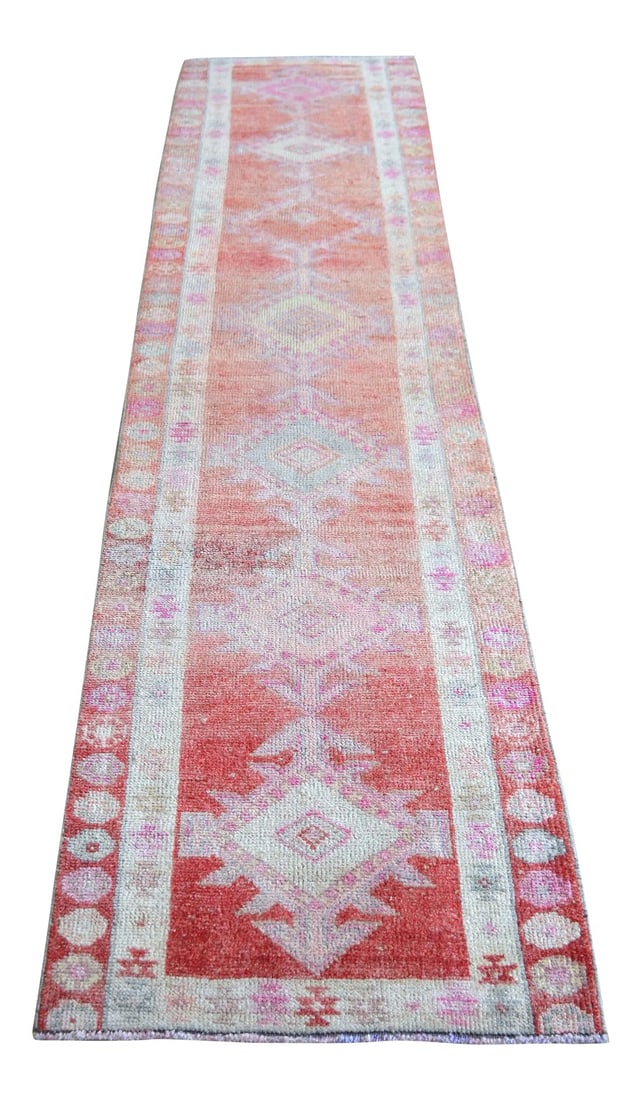 Kurdish Herki Hand-Knotted Distressed Runner Rug: Offered is an one of a kind Kurdish runner rug, made in Anatolia approximately 50-60 years ago. The beautiful wool on cotton pile features multicolored geometric patterns on a wavy pale red
