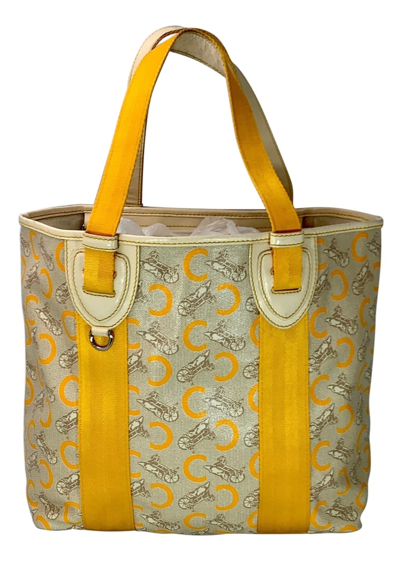 Pre-Loved Celine Yellow Beige Canvas Coated PVC Plastic Macadam Tote Bag: Celine Yellow Beige Canvas Coated PVC Plastic Macadam Tote Bag Bag is in Excellent condition Inside is Beige canvas , Very Clean , Zippered Hanging pocket with slip pockets. Measurements Length 12 "