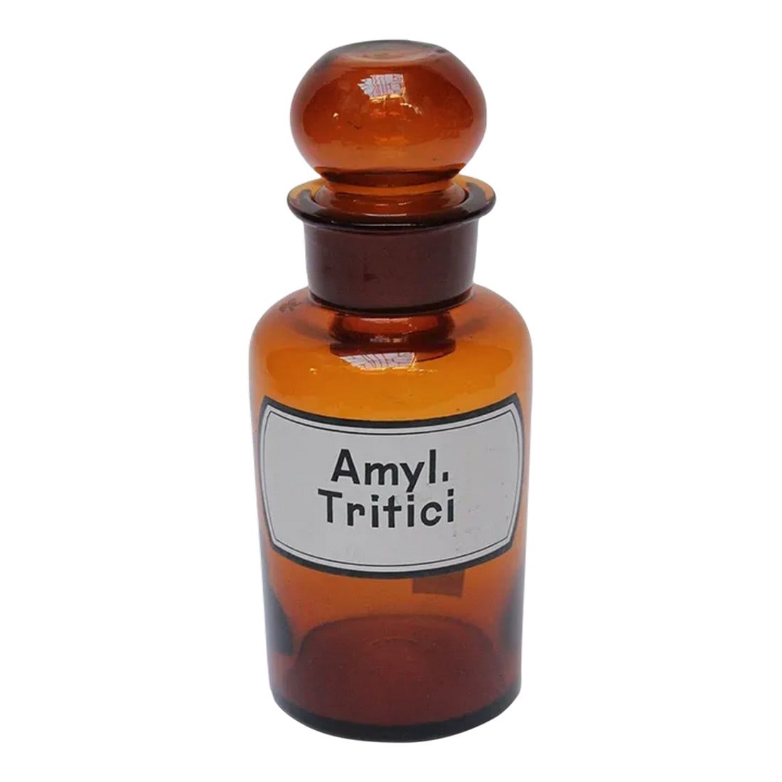 Vintage German Amber Glass "Amylum Tritici" Apothecary Bottle: Amyl. Tritici' (Amylum Tritici) pharmacy bottle/apothecary jar (circa late 1920s/early 1930s, Germany). Amber glass with orb stopper and enamel label. "36" is marker applied to the bottle itself and
