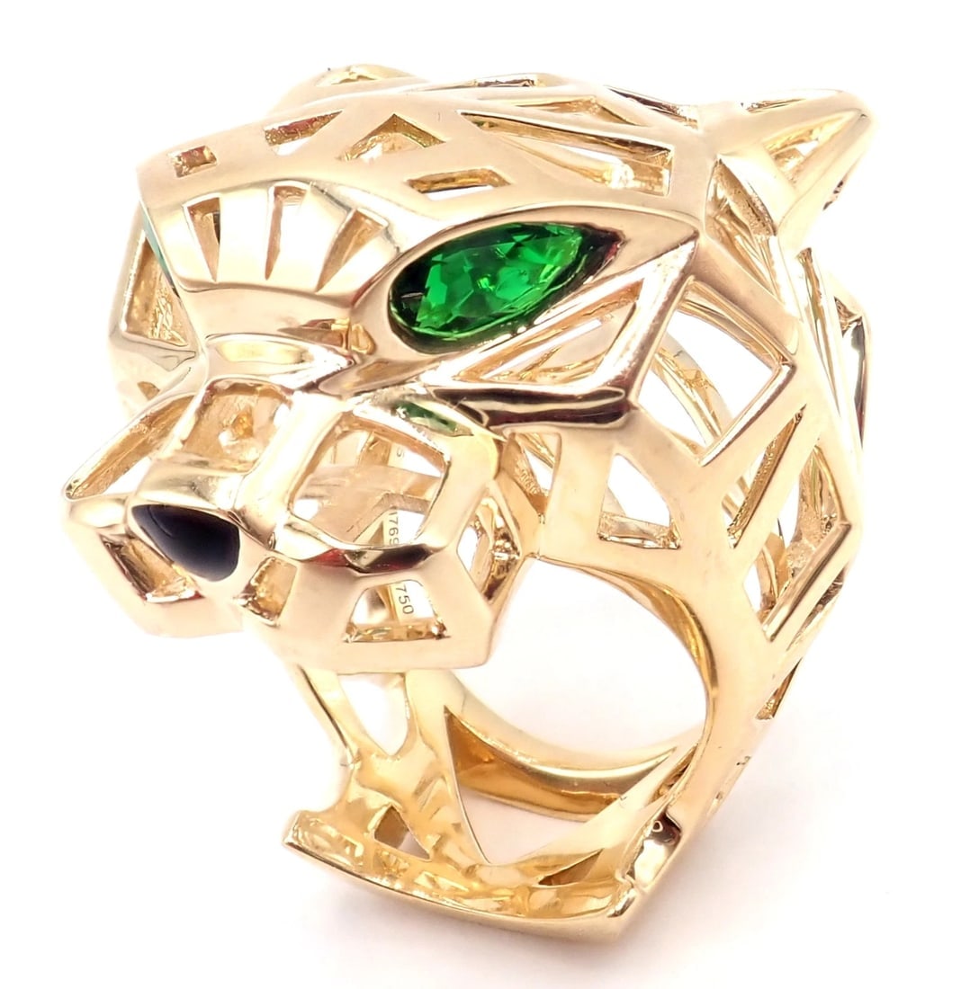 Authentic! Cartier Panther Panthere 18k Yellow Gold Tsavorite Onyx Large Ring: Authentic! Cartier Panther Panthere 18k Yellow Gold Tsavorite Onyx Large Ring About This Piece: Metal: 18k Yellow Gold Measurements: Width: 1 1/4" Weight: 23.7 grams Stones: 2 tsavorite garnets in the