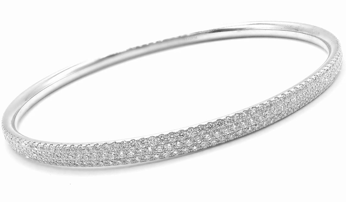 Tiffany & Co Metro 18k White Gold Full Diamond Three Row Bangle Bracelet $22,300: Tiffany & Co Metro 18k White Gold Full Diamond Three Row Bangle Bracelet $22,300 About This Piece: Retail Price: $22,300 Metal: 18k White Gold Size: Medium 6.25" Weight: Width: 22.3 grams 4mm Stones:<