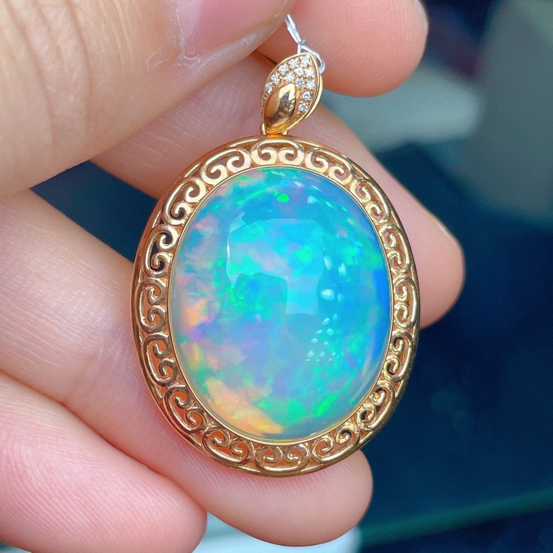 14K GOLD 14.23 CT NATURAL OPAL & DIAMOND PENDANT: Title:14K GOLD 14.23 CT NATURAL OPAL & DIAMOND PENDANT Description:Ref:230528345Gold Content:14K GoldMain Gemstone:OpalNumber of stones:1Shape:OvalCarat Weight:14.23ct Color:WhiteTreatment:NaturalCut