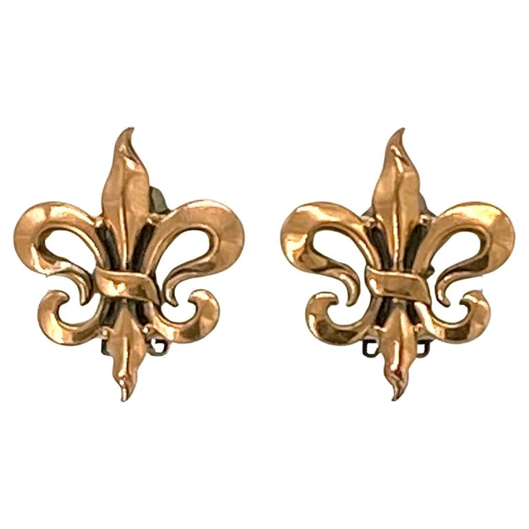 Renoir Fleur de Lis Copper Clip-on Earrings: This is a 1950s Renoir of California copper bracelet. Nine panels link with eight stylized leaves. The artificially added dark patina gives greater visual interest. It is signed Renoir on the fold bac
