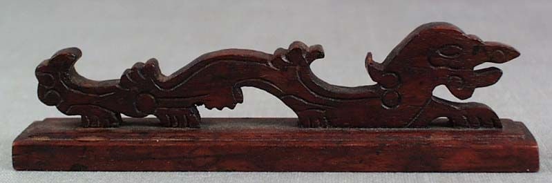 19c Chinese scholar huanghuali BRUSH REST DRAGON: 19th century Chinese wooden brush rest carved in the form of a crouching dragon on a base. Dense hardwood (must be wood species related to huanghuali), wonderful warm patina, old nicks, ink and water