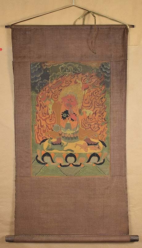 18c Tibetan thangka DHARMAPALA BEGTSE: 18th century Tibetan thangka in original mounts depicting Begtse standing on a lotus throne trampling on the corpses of horses and humans, brandishing a sword, supporting a lance and a bow and