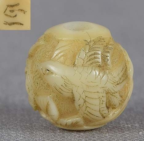19c marine ojime netsuke slide BIRD flower rock by GYOKUICHI: 19th century small marine material ojime (slide bead for tightening the cord going from netsuke to inro) carved in the round with a bird in flight by a rock and blooming peony bush. Wonderful